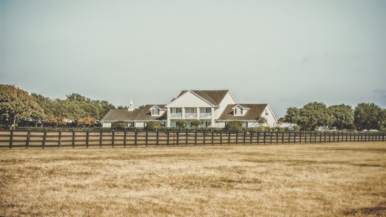 White two-story house near trees representing Texas homestead home equity loan rules