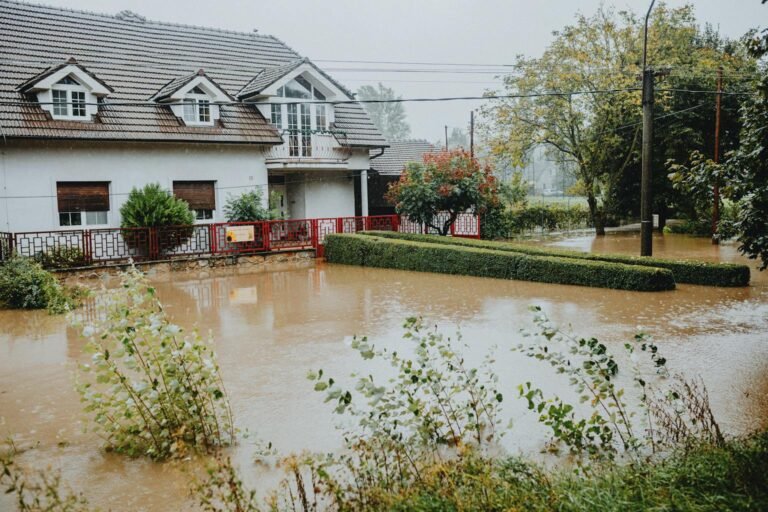 suburban house surrounded by floodwater showing Texas flood zone risk