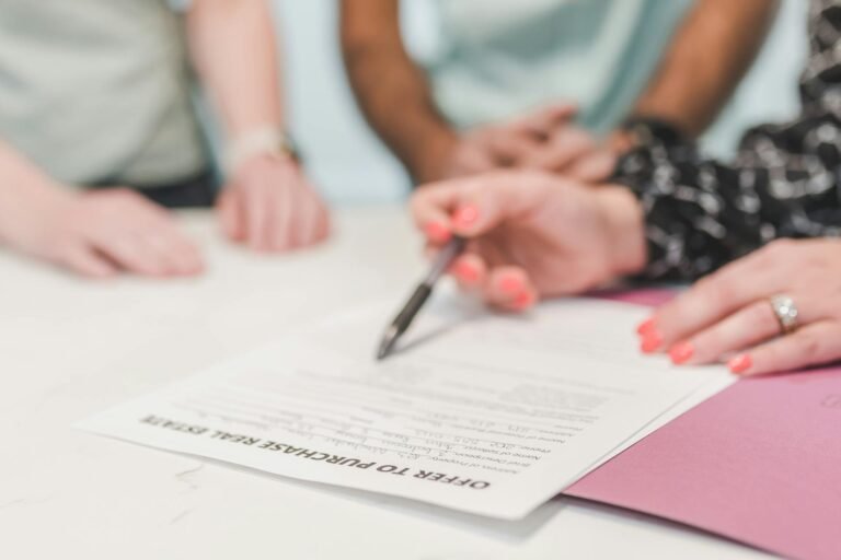 Real estate professionals reviewing title insurance documents at a Texas closing meeting