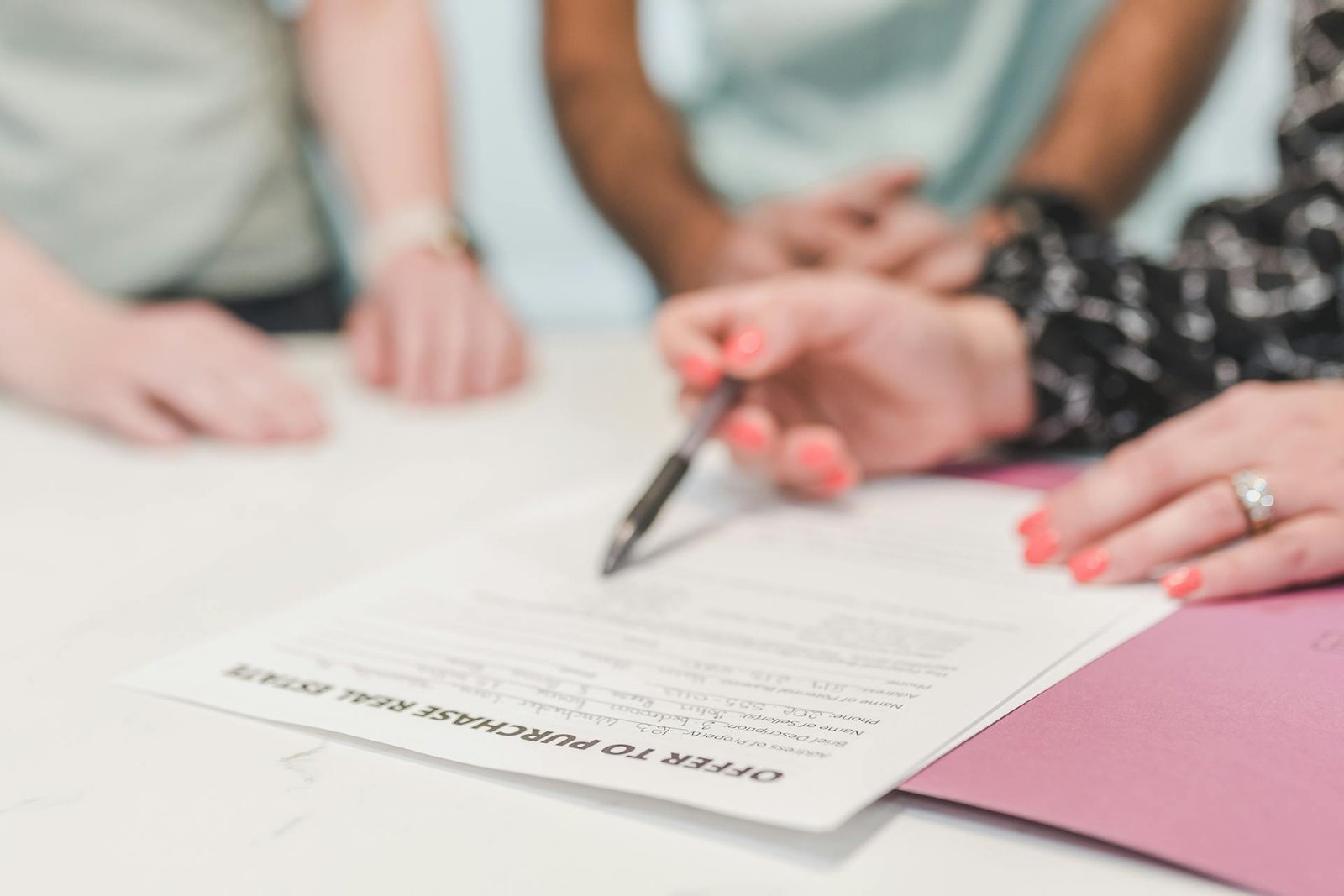 Real estate professionals reviewing title insurance documents at a Texas closing meeting