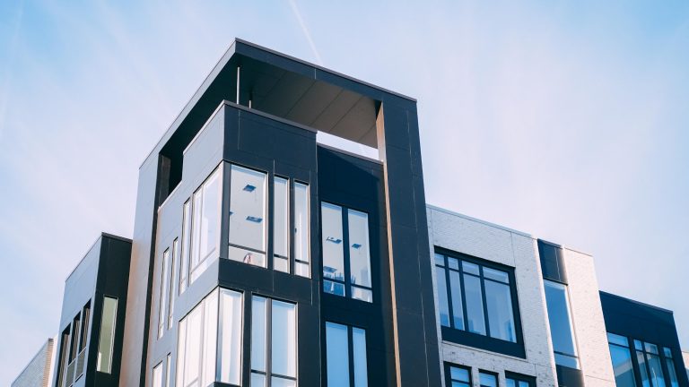 Modern multi-unit condo building, the kind of project lenders review for warrantability in Texas