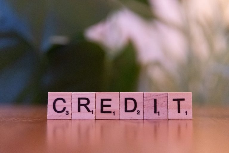 Wooden blocks spelling CREDIT representing credit score requirements for a Texas mortgage