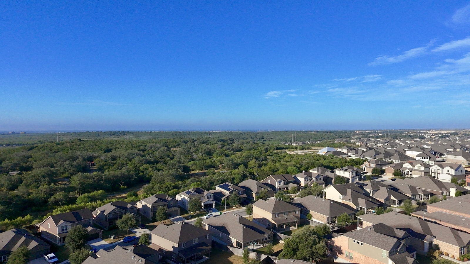 Texas suburban neighborhood with homes among green trees, illustrating homeowners insurance and the mortgage payment