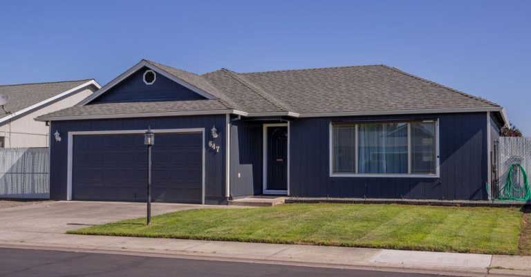 Suburban family house with driveway and lawn, the kind of inherited home Texas families decide to keep or sell