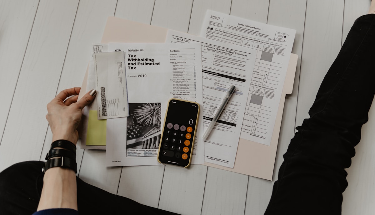 Person calculating mortgage discount points with paper and calculator in Texas