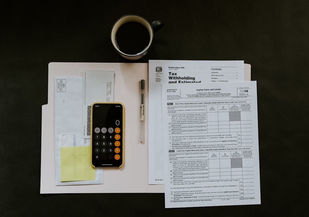 Calculator and household budget paperwork used to figure a debt-to-income ratio for a Texas mortgage